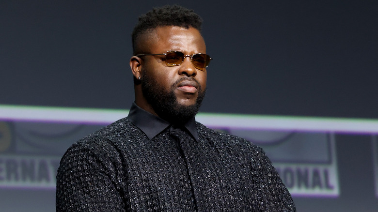 Winston Duke serious in shades