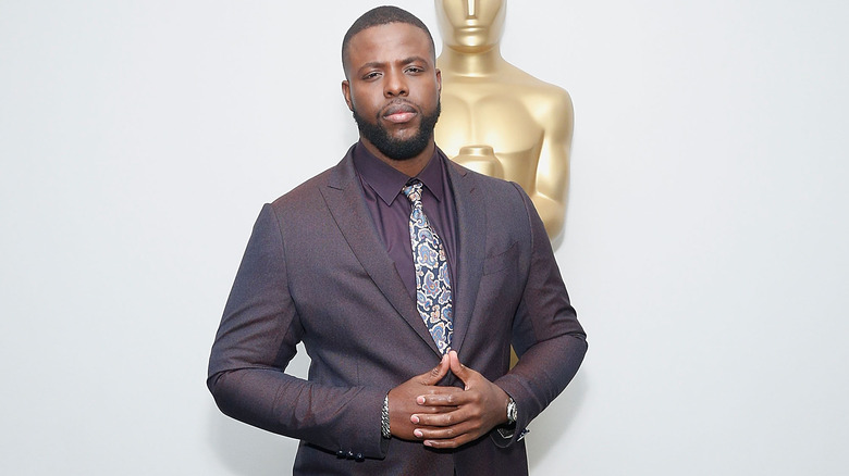 Winston Duke hands on stomach