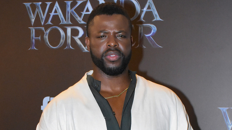 Winston Duke posing, monochrome shirt