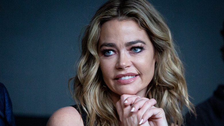 Denise Richards, posing with hands folded