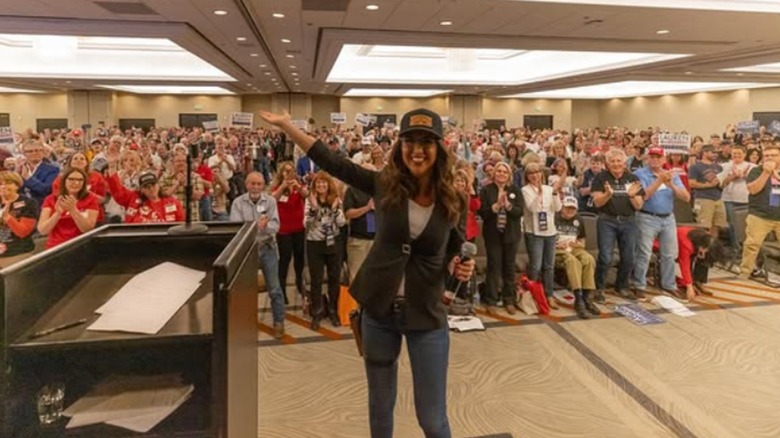 Lauren Boebert poses in front of a crowd of supporters.