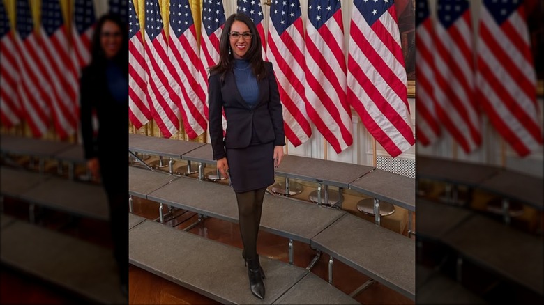 Lauren Boebert poses in front of American flags at The White House.