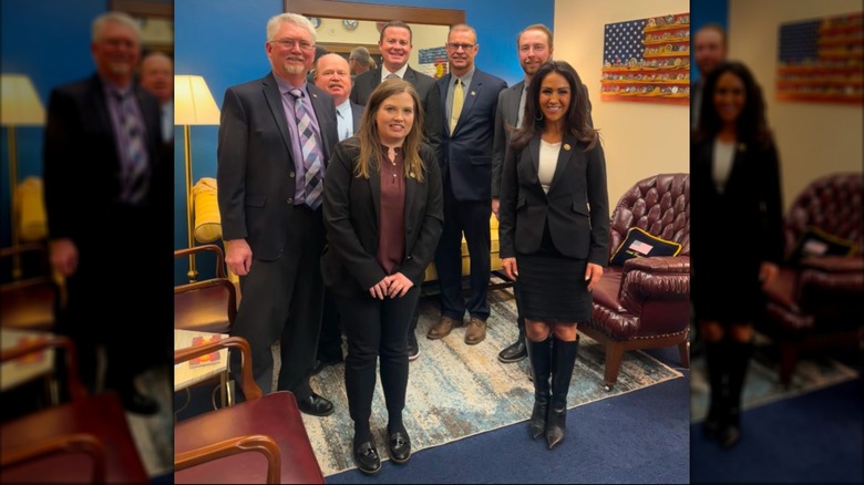 Lauren Boebert posing with wheat growers.