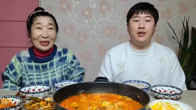 A Loving Couple sitting at the table with their food.