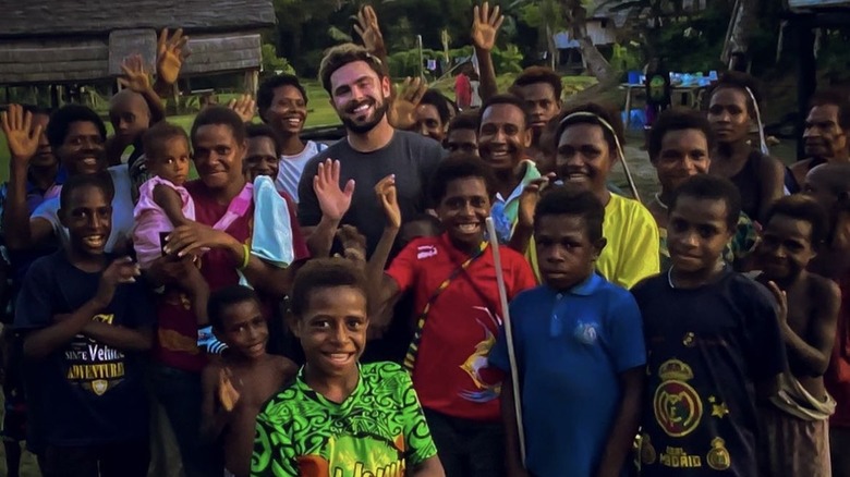 Zac Efron waving with children in Papua New Guinea