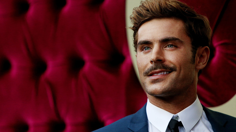 Zac Efron smiling, looking up