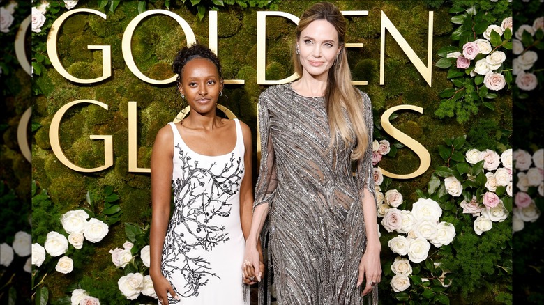 Zahara Jolie holding hands with Angelina Jolie at the 2025 Golden Globes