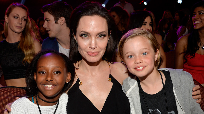 Angelina Jolie with arms around Zahara and Shiloh Jolie at the 2015 Kids' Choice Awards