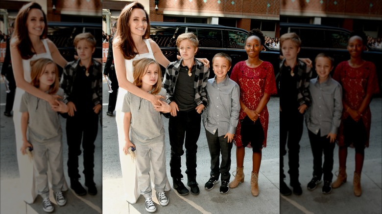 Zahara Jolie wearing red lace dress and posing with family at "The Breadwinner" premiere during the 2017 Toronto International Film Festival