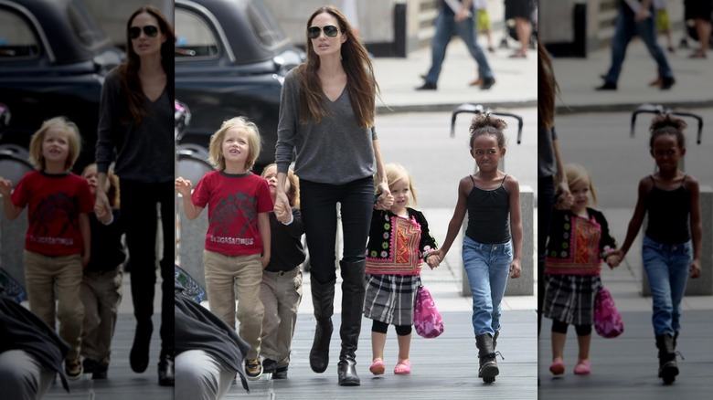 Young Zahara Jolie holding hands with Vivienne Jolie-Pitt during walk with family