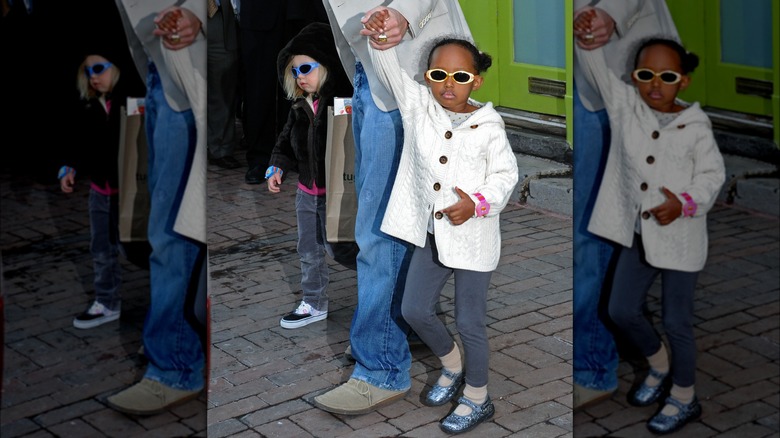 Young Zahara Jolie wearing sunglasses and white sweater