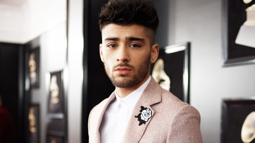 Zayn Malik walks the red carpet at the Grammy Awards